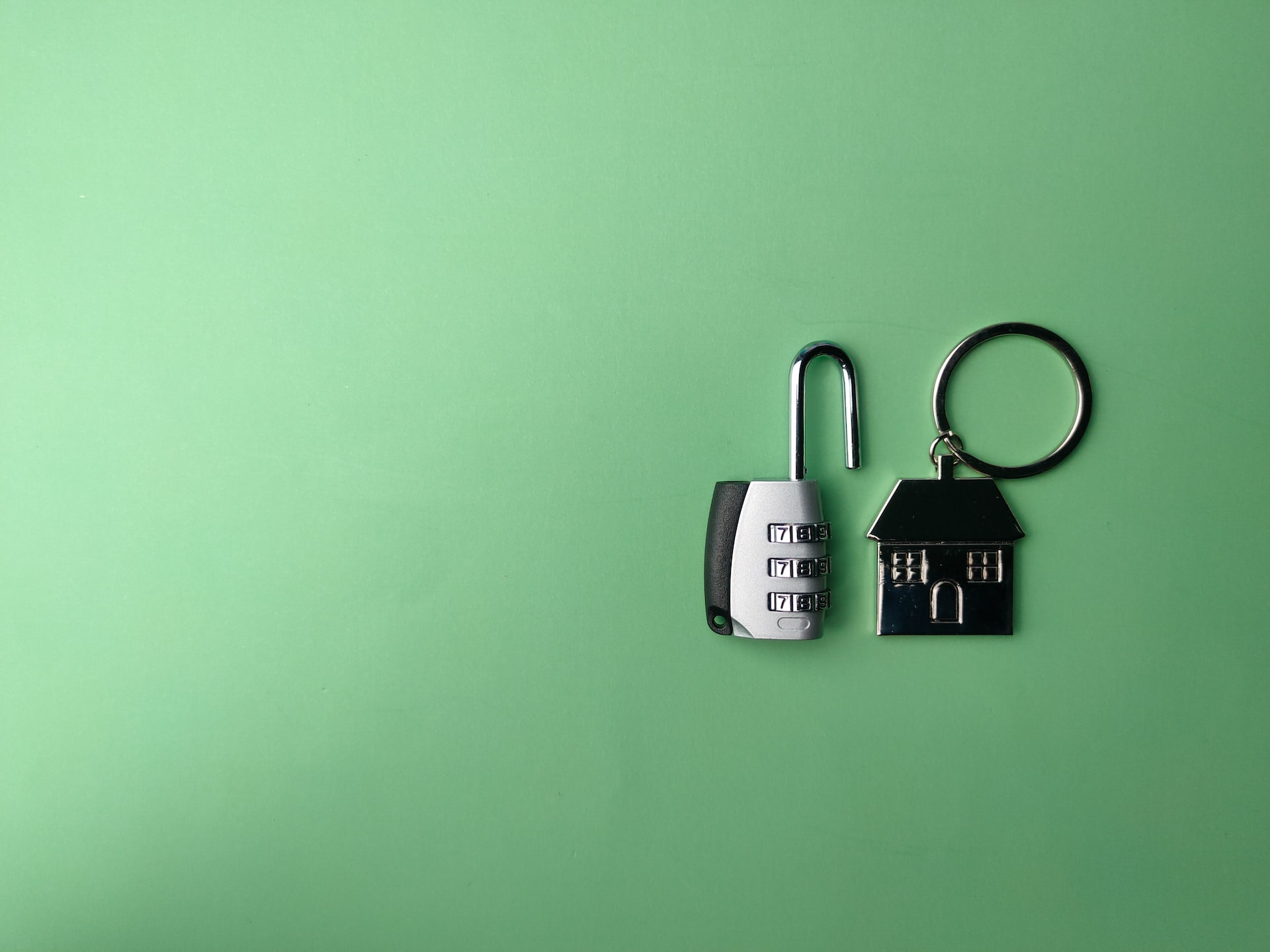 A lock and key fob in the shape of a house